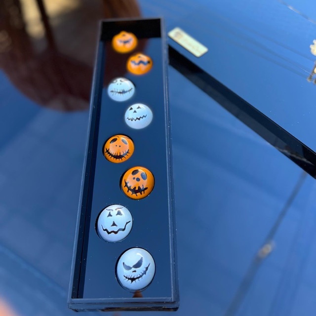 The full long black gift box of orange and white Halloween face chocolates
