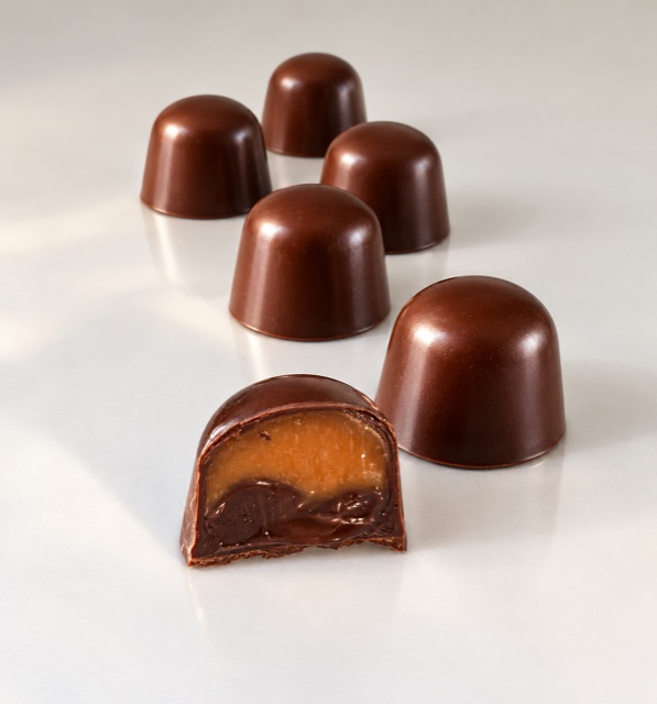 Chocolate truffles with one cut open to reveal its layered filling